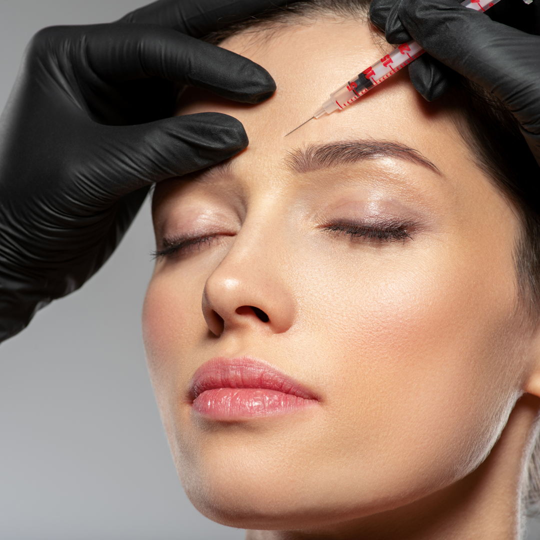 Client receiving a facial neuromodulator injection in a modern, luxurious medical spa with soft lighting and natural decor in Santa Barbara