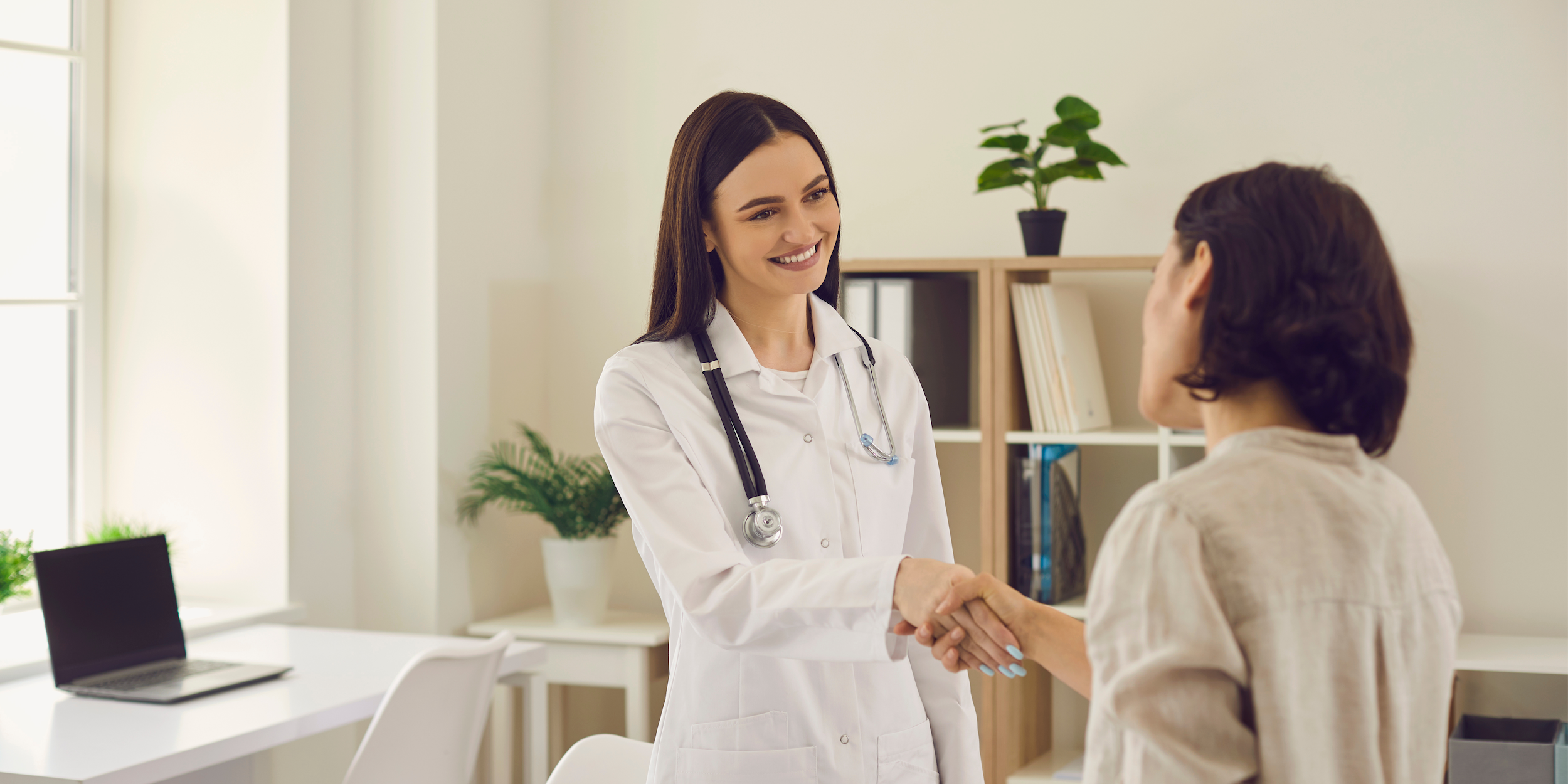 Female nurse practitioner consulting with a woman about starting bioidentical hormone replacement therapy for perimenopause in a calm, modern medical spa setting.